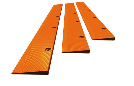 Plate Locks in bright orange, designed for securing road plates on construction sites.